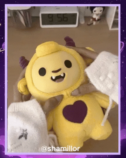 Yellow KUTI emotional support plush toy with heart
